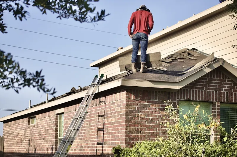 Professional roofer working on a residential roof in Brandywine Farms
